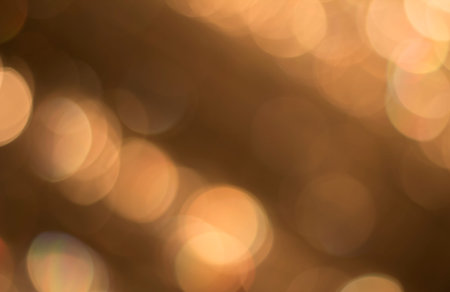 Background with bokeh for design. Natural golden lights.の写真素材
