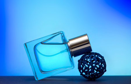 Perfume bottle on a blue background. Eau de Toilette.