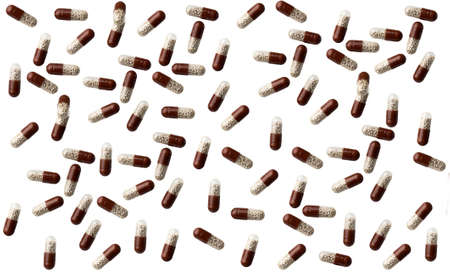 Falling brown medication capsules isolated on white background.の写真素材