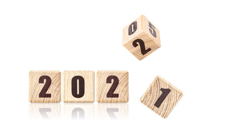 Wooden cubes with the inscription 2022, 2021. Christmas background.