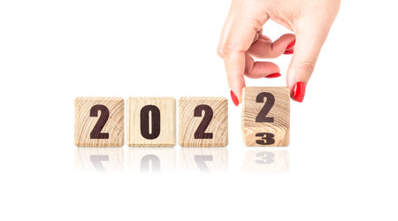 Wooden cubes with the inscription 2022, 2023. Christmas background.の写真素材