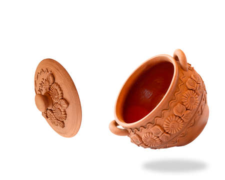 Clay pot with a lid is flying on a white background. Levitation.の写真素材