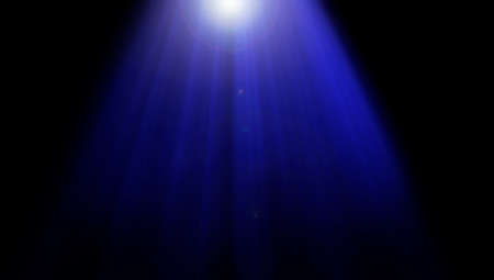 Blue rays of light from above on black.の写真素材