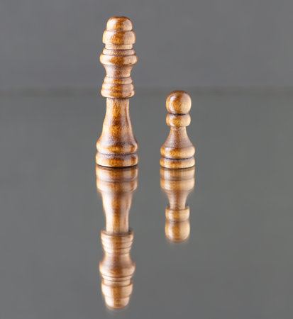 The chess queen and the pawn are reflected.の写真素材
