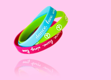 Bracelets with the symbol of peace on a pink background.の写真素材