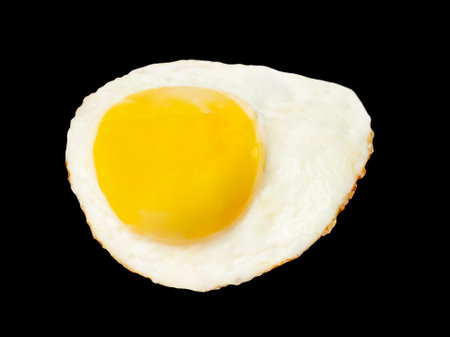 Fried egg levitation isolated on black background.の写真素材