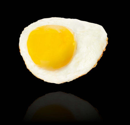 Fried egg levitation isolated on black background.の写真素材