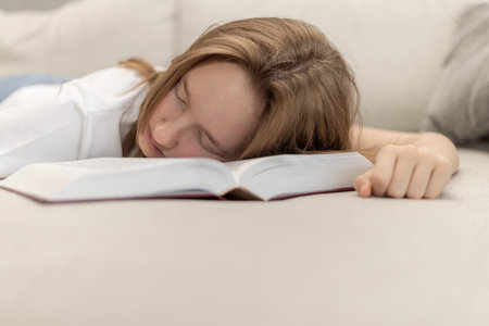 The child fell asleep on the book.の写真素材