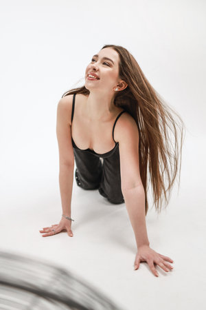 Beautiful girl with flying hair on a white background.の写真素材