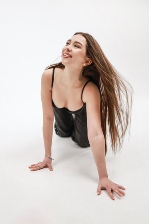 Beautiful girl with flying hair on a white background.の写真素材