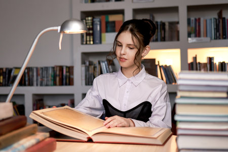 A girl in the library with a book.の写真素材