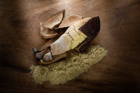 Delicious fruit of carob tree on a wooden background