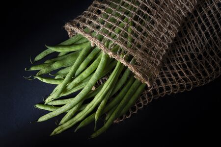Round beans, inside a sack of fique, on a dark backgroundの写真素材