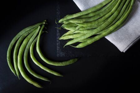 Round beans, a cloth napkin and a black backgroundの写真素材