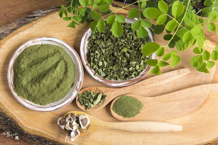 Moringa, leaves, seeds, powder on a wooden background - Moringa oleiferaの写真素材