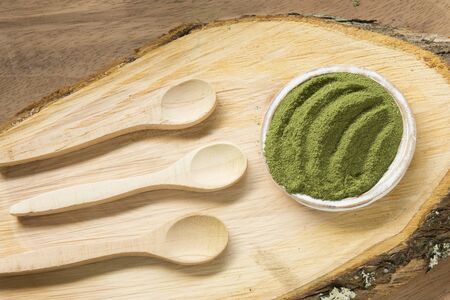 Moringa, leaves on a wooden background- Moringa oleiferaの写真素材