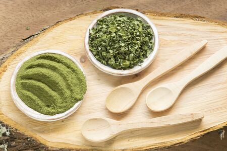 Moringa, leaves and powder on a wooden background- Moringa oleiferaの写真素材