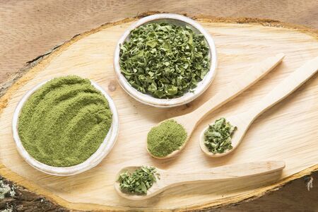 Moringa, leaves and powder on a wooden background- Moringa oleiferaの写真素材