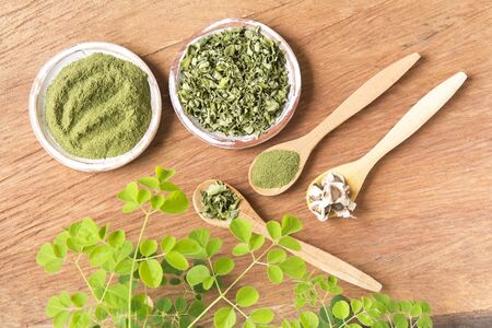 Moringa, leaves, seeds, powder on a wooden background - Moringa oleiferaの写真素材