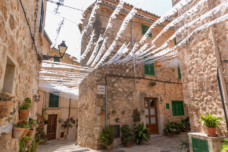 VALLDEMOSSA, PALMA DE MALLORCA, SPAIN. JULY 21, 2019. Beautiful streets of Valldemossa adorned with garlands and flowers in honor of Santa Catalina Tom?s.のeditorial素材