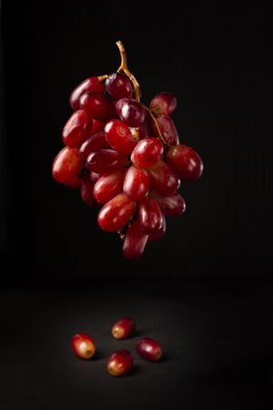 Bunch of table grapes on black backgroundの写真素材