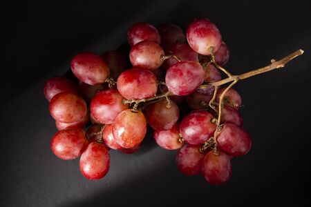 Bunch of table grape on black backgroundの写真素材