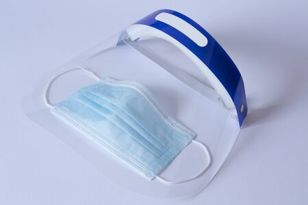 Surgical mask and visor to prevent coronavirus. All on white background.の写真素材