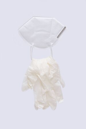 Surgical mask and latex gloves to prevent coronavirus. All on white background.の写真素材
