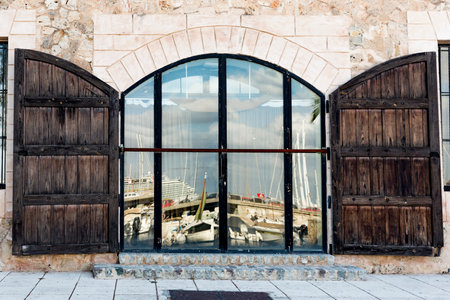 Palma de Mallorca, Spain. July 25, 2017. View of the port of Palama reflected in a window on El...