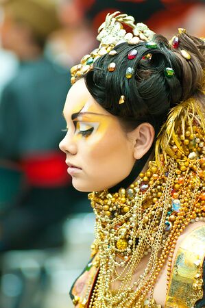 MOSCOW, RUSSIA - FEBRUARY 12: model in gold walks the runway during the VIII Open Championship for creative makeup KOSMETIK international on February 12, 2011 in Moscow, Russia.のeditorial素材