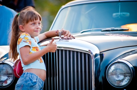 MOSCOW, RUSSIA-JULY 31: Little Girl and retro car  in exhibition parking at an annual event, the VI race of vintage cars 'Night Moscow Classic Rally'. July 31, 2010 in Moscow, Russiaのeditorial素材