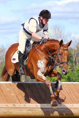 MOSCOW - AUGUST 21: Sharauchov Igor on Klever on a Russian Cross-Country Championship, August 21, 2010 in Moscow, Russia/Rider horseback on jumping red chestnut horseのeditorial素材