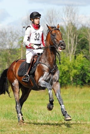 MOSCOW - AUGUST 21: Men'shikova Julija on Kinzhal on a Russian Cross-Country Championship, August 21, 2010 in Moscow, Russia/Rider horseback on galloping brown chestnut horseのeditorial素材