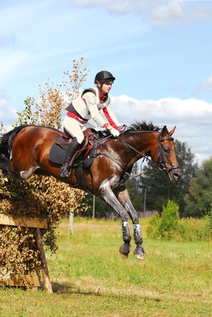 MOSCOW - AUGUST 21: Sharauchov Igor on Klever on a Russian Cross-Country Championship, August 21, 2010 in Moscow, Russia/Rider horseback on jumping red chestnut horseのeditorial素材