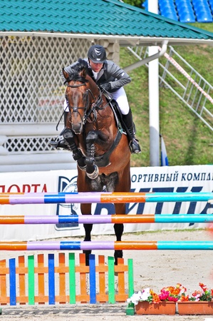 MOSCOW, RUSSIA-JUNE 26: Rider Chistyakov Spartacus wiht a Holsten horse Baskyul competes at the International event CSI4*RR/ Russian Championship Show Jumping on June 26, 2011 in Moscow, Russiaのeditorial素材