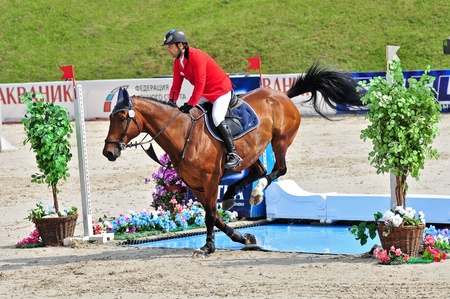 MOSCOW, RUSSIA-JUNE 26: Rider Raag Urmas (EST) with a Belgian horse Axel du Beaumont competes at the International event CSI4*RR/ Russian Championship Show Jumping on June 26, 2011 in Moscow, Russiaのeditorial素材