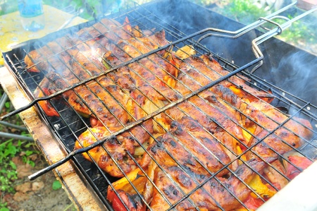 chicken wings on smoking grill in the gardenの写真素材