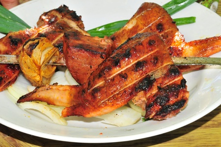 white plate with chicken wings on smoking grill in the gardenの写真素材