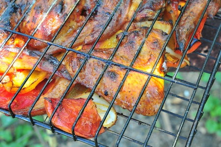 chicken wings on smoking grill in the gardenの写真素材
