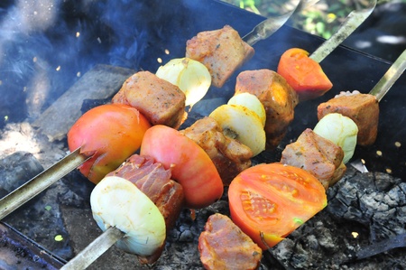 delicious meat on smoking grill in the gardenの写真素材