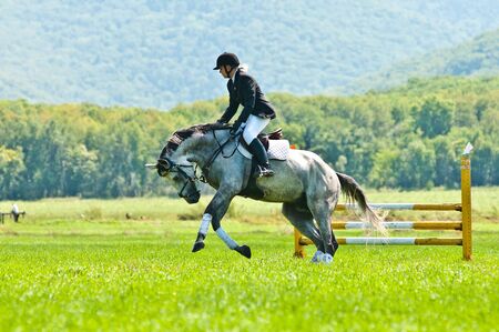 ARSENEV, RUSSIA - SEPTEMBER 03   Unidentified rider in action rides horse show jumps at the Riding show  The Cup of the Governor of the Primorsky Territory, 2011  on Sept 03, 2011 in Arsenev, Russiaのeditorial素材