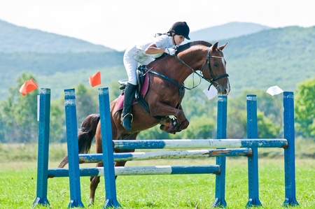 ARSENEV, RUSSIA - SEPTEMBER 03   Unidentified rider in action rides horse show jumps at the Riding show  The Cup of the Governor of the Primorsky Territory, 2011  on Sept 03, 2011 in Arsenev, Russiaのeditorial素材