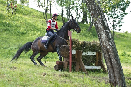 MOSCOW - JUNE 02  Unidentified rider on horse jumping over a hurdle at the International Eventing Competition CCI3  のeditorial素材