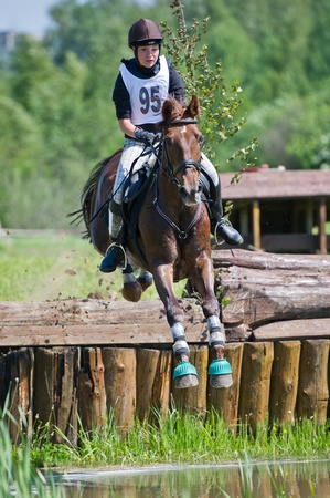MOSCOW - JUNE 02  Unidentified rider on horse  Woman eventer on horse is Drop fence in Water jump at the International Eventing Competition CCI3 2  1 Russian Cup Eventing June 02, 2012 in Moscow, Russiaのeditorial素材