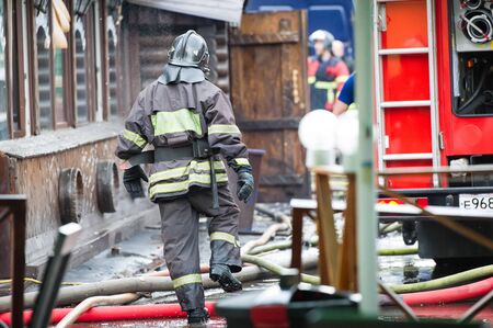 fire fighters walking away building in the drops of water after putting out the fireの写真素材