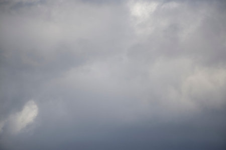 Background of real heavy clouds. Background summer sky. Gray background. Gray sky background with...
