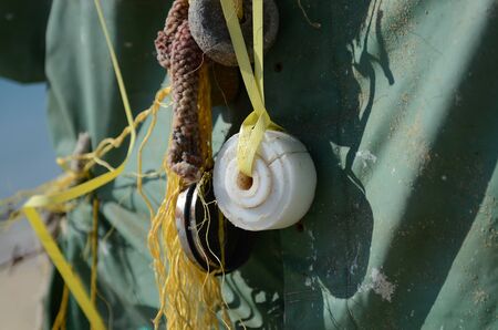 Close up Scarecrow made of plastic and other rubbish thrown out of the sea. Plastic, nets, barbed wire, sinks. By the sea on the beachの写真素材