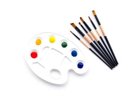 On a white isolated background, a palette of basic colors and a set of brushes for drawing.の写真素材