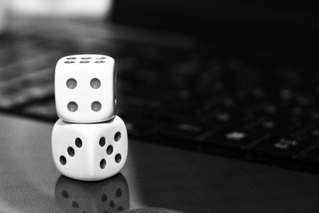 two white dices on a computer keyboard, gameの写真素材
