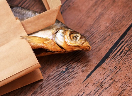 Dried fish on the table. Salty dry river fish on a wooden impressive background.の写真素材